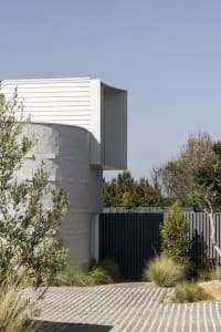 Modern residential architecture featuring concrete elements and outdoor spaces.