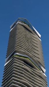 A modern high-rise building with a facade made of concrete and glass