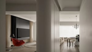 Modern living room with wood floors, metallic fixtures, and contemporary furniture.