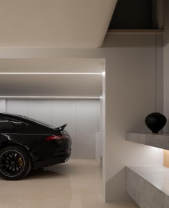 Modern garage interior with a sleek black car, concrete flooring, and minimalist design.