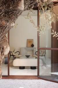 A modern living room featuring glass and marble elements.