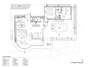 Architectural layout of a modern residential interior featuring a concrete floor plan with open living spaces, a kitchen, and