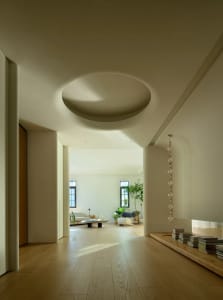 A modern living room with white walls and wooden flooring.