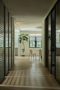 A modern, spacious living area with wooden flooring and a large window.