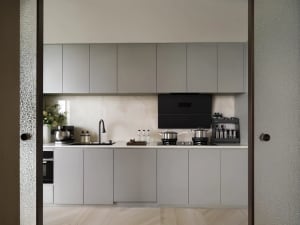 Modern, minimalist kitchen with gray oak cabinets, stainless steel appliances, and a neutral color palette.