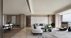 Modern living room featuring a neutral-toned wooden floor, contemporary furniture including a beige sectional sofa, and minim