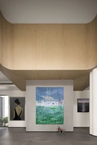 Modern art gallery interior with large abstract artwork and wooden walls