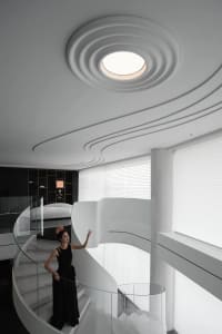 A modern home interior featuring concrete and glass elements.