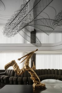 A modern interior design featuring metal wire art installations.