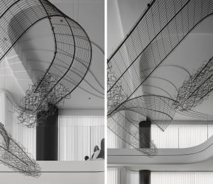Modern interior design featuring metal netting hanging from the ceiling.