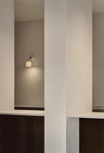 An interior design featuring minimalist decor with concrete walls.