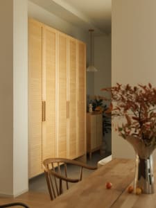 A modern interior design featuring wooden cabinets in a living room setting.
