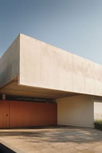 A modern building with concrete blocks and an orange garage door.