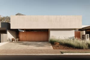 Modern house with concrete exterior, geometric design, and minimalist aesthetic.