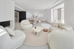 A modern living room with neutral-toned furniture and a minimalist aesthetic.