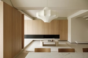 Modern minimalist living room with wooden furniture and marble accents