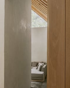 Modern living room with concrete and wooden walls and ceiling