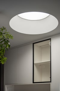 Modern minimalist interior with a glass panel wall closet