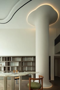 A modern library space featuring white concrete columns, clean lines, and minimalist design.