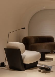 Modern living room with textured fabric seating and sleek lighting.