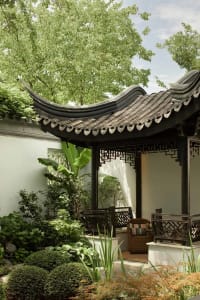 A serene Chinese landscape garden featuring a traditional tile-roof gazebo.