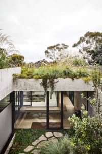 Modern residential home with concrete, glass, and natural stone materials