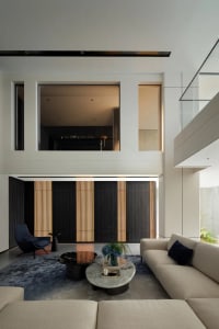 A modern interior design featuring a concrete living room with minimalist furniture and a large window.