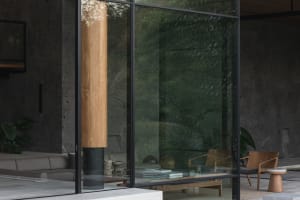 Modern lounge area featuring glass walls and concrete elements.