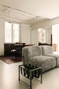 Modern living room featuring a patterned sofa on white flooring