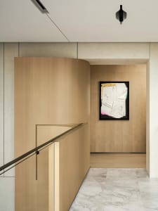 Modern interior design featuring wooden panels and marble wall