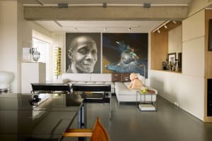 Modern living room with a white leather sectional sofa, concrete beams, and minimalist decor.