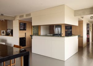 A modern residential kitchen with granite countertops and minimalist design.