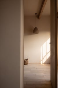 Minimalist bedroom featuring a wooden floor with natural light.