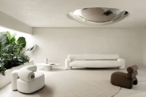 A modern white living room with concrete accents and minimalist furniture.