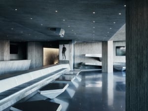 Modern, industrial-style interior with concrete walls and floors, featuring sleek, minimalist furniture and a dramatic, monoc