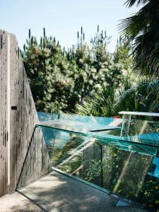 A modern residential exterior with concrete and glass elements.