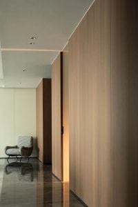 A minimalist interior design featuring wood paneling and marble flooring