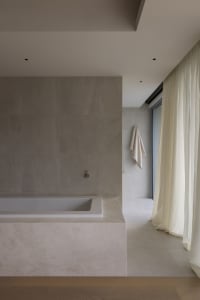 Modern minimalist bathroom featuring marble finishes and a serene atmosphere.