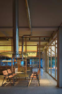 Industrial-style retail space featuring metal pipes and wooden furniture.