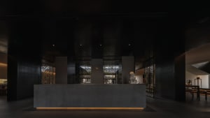 A modern lobby featuring a metal counter with a dark, sleek design.