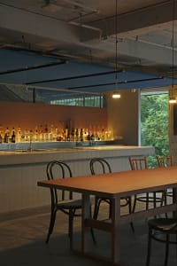 Industrial-style bar with concrete, tile, and exposed pipes