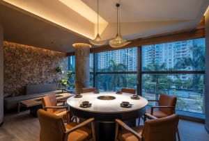 An industrial-style restaurant with marble accents and seating.