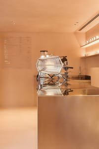 Modern coffee shop interior with a steel-clad counter top and minimalist design.