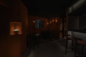 Industrial-style restaurant interior with concrete walls and ambient lighting