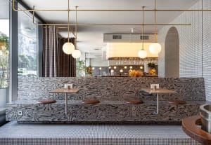 Modern restaurant interior featuring wood, glass, and metal materials.