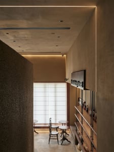 Modern cafe interior featuring wooden shelves and tables