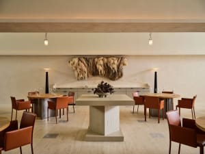 A modern restaurant interior with concrete accents and minimalist decor.