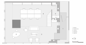 A modern office space featuring neutral-colored flooring and furniture, with a conference table and seating arrangements.