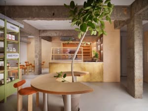 A modern coffee shop interior with wooden furniture and minimalist design.