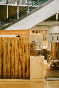 A restaurant interior with bamboo walls and furniture